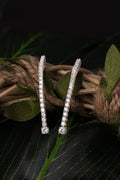 Diamond tennis drop earrings in white gold