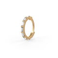 Gold hoop earring with baguette cut gemstones on a white background