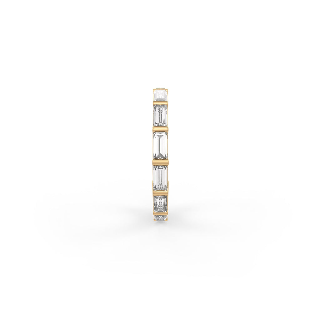 A slim vertical diamond band ring featuring baguette-cut diamonds in a yellow gold setting