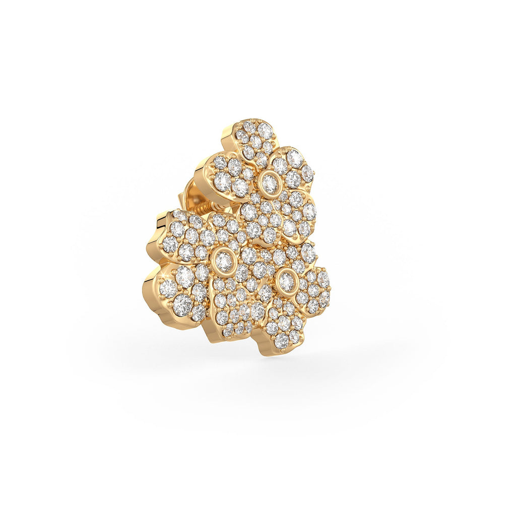 Gold ring with diamond floral design on a white background