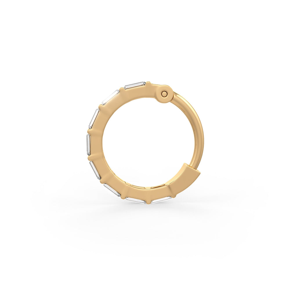A gold huggie hoop earring with small rectangular clear stones set along the front edge, shown on a clean white background