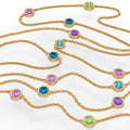 Delicate yellow gold necklace with vibrant gemstone
