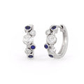 Pair of silver hoop earrings with blue gemstones