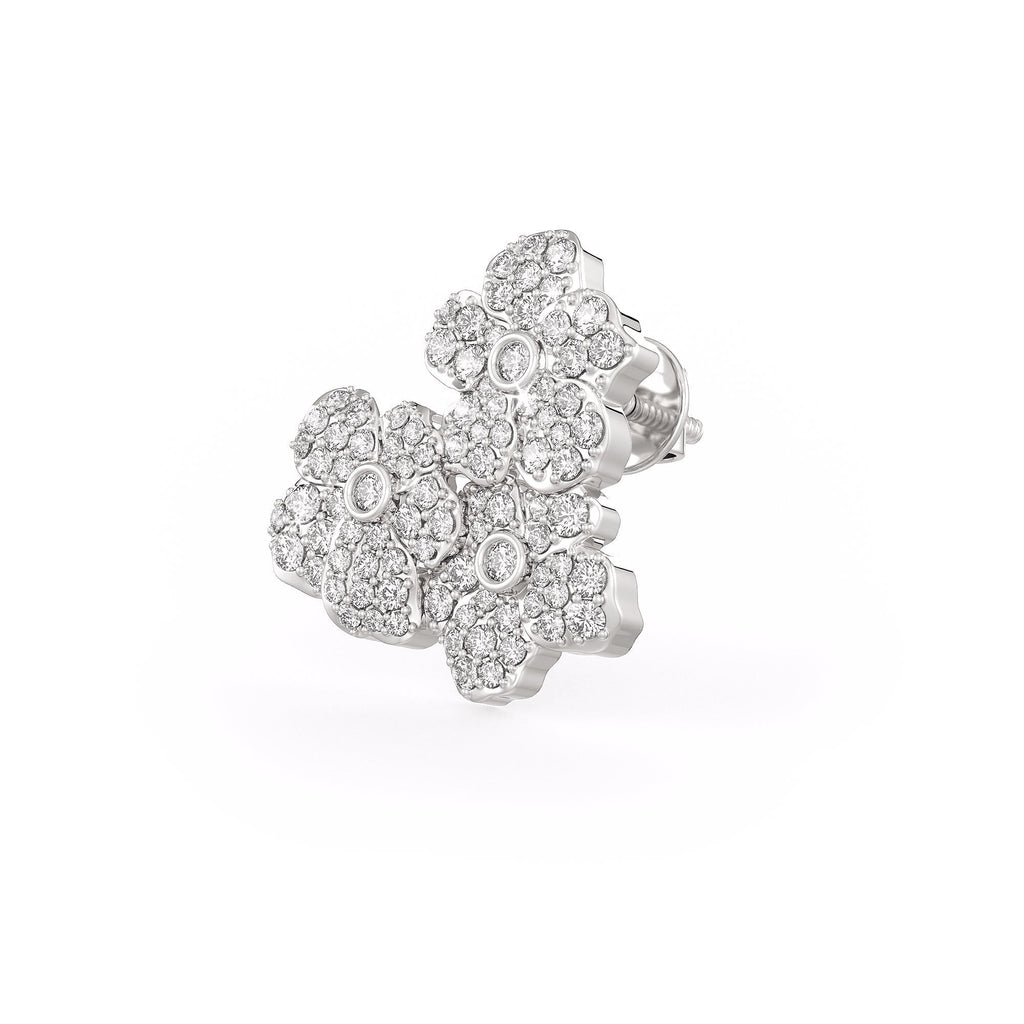 Silver floral earring with clear gemstones on a white background