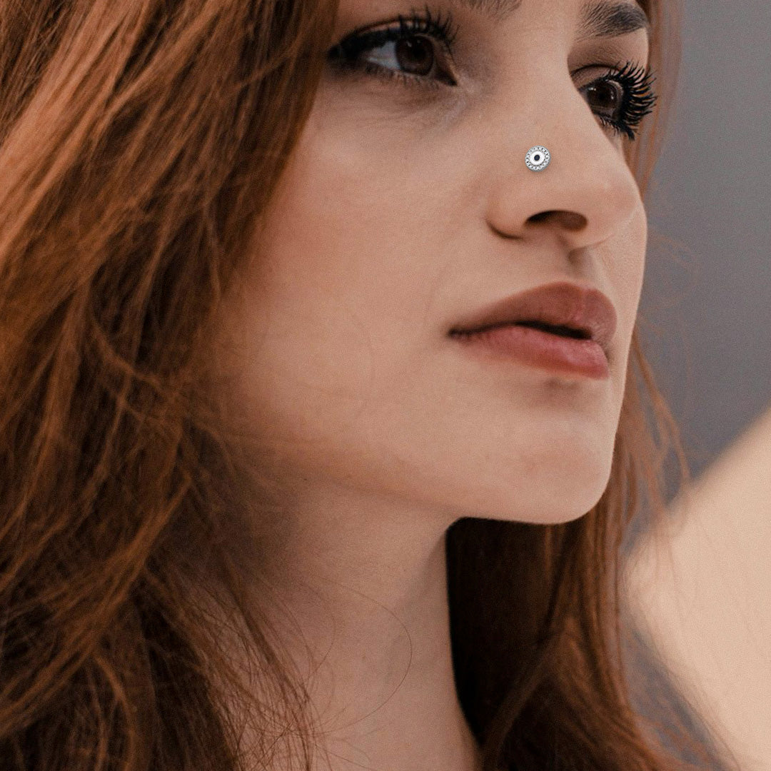 Close up of a woman with a nose stud and brown hair