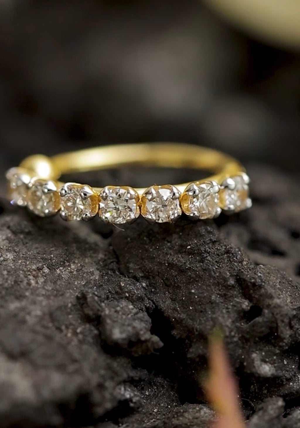 Gold stud with diamonds on a dark textured surface