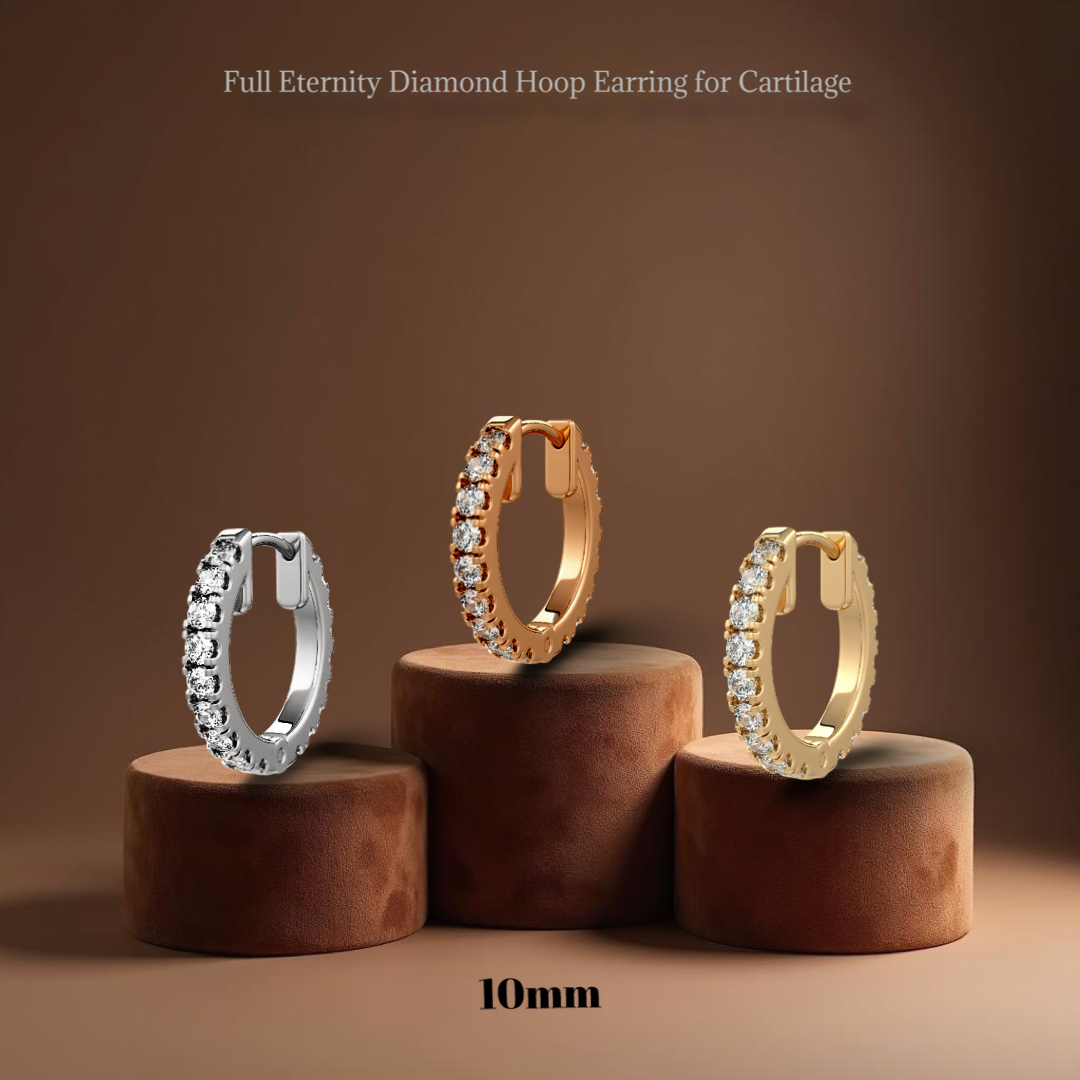 Three diamond hoop earrings on brown stands with a brown background