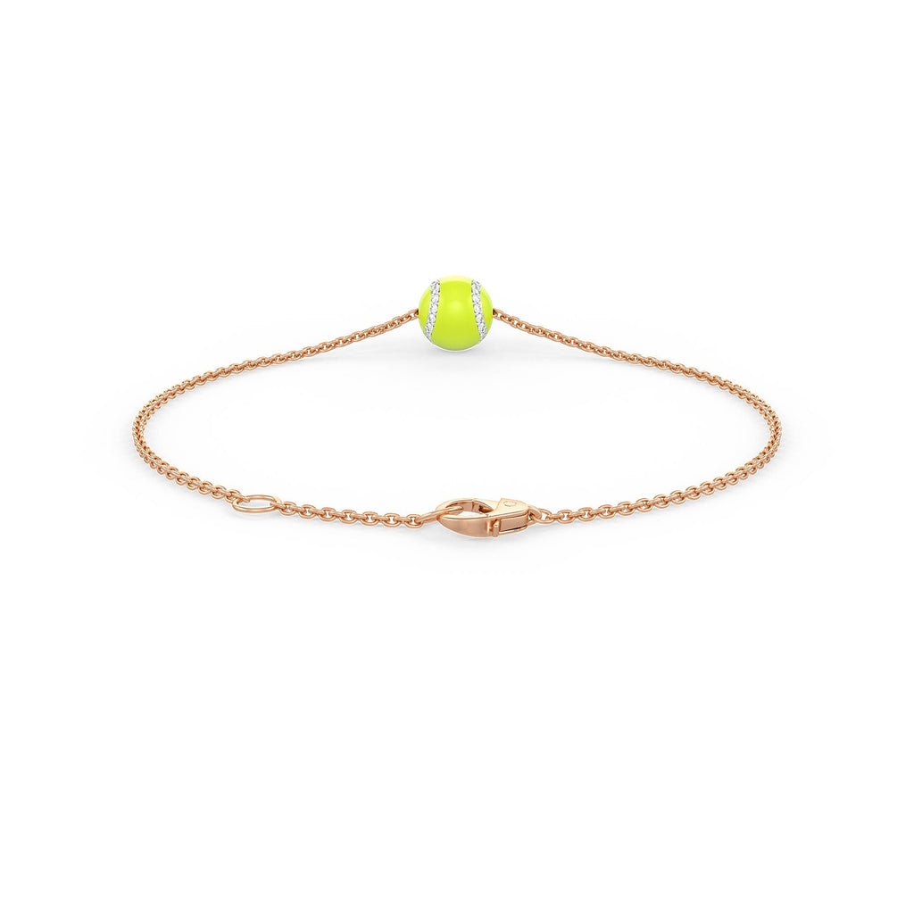 Gold bracelet with a tennis ball charm on a white background