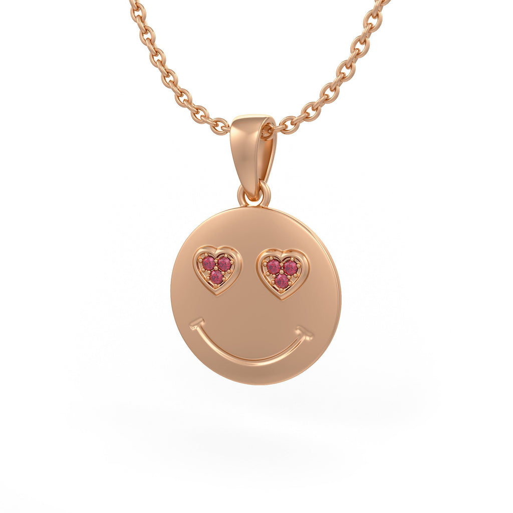 Rose gold smiley face pendant with heart shaped gemstones and pink stones