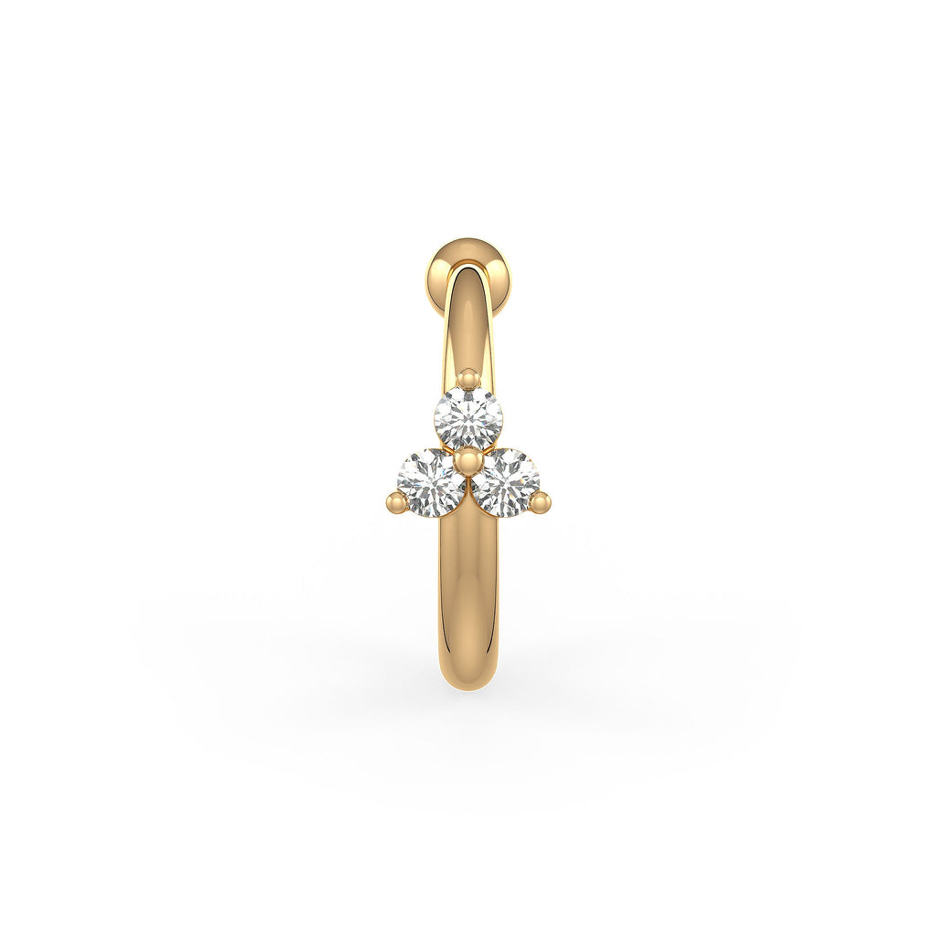 Gold nose ring with three clear gemstones on a white background
