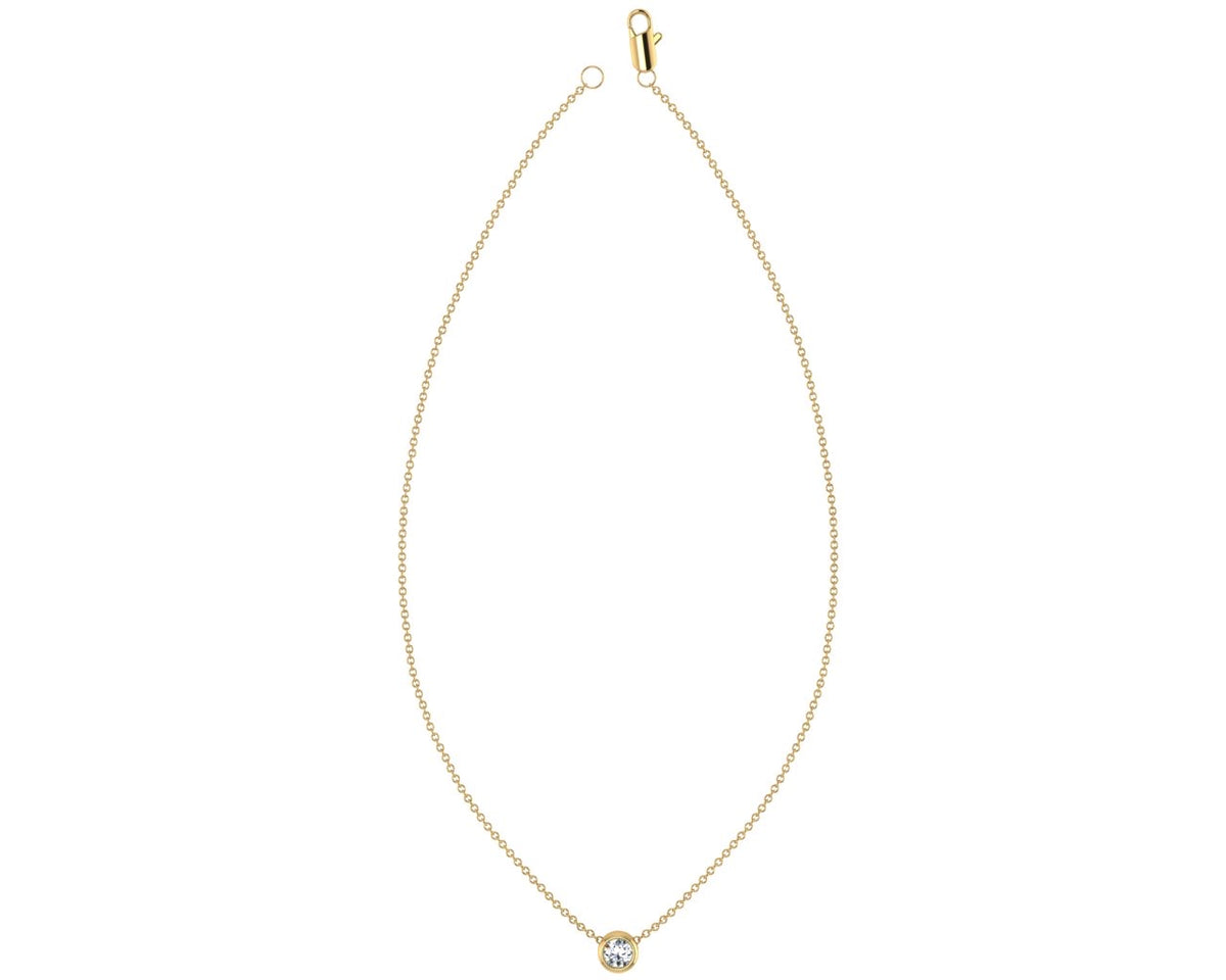 Bezel set 0.11ct diamond pendant on yellow gold necklace