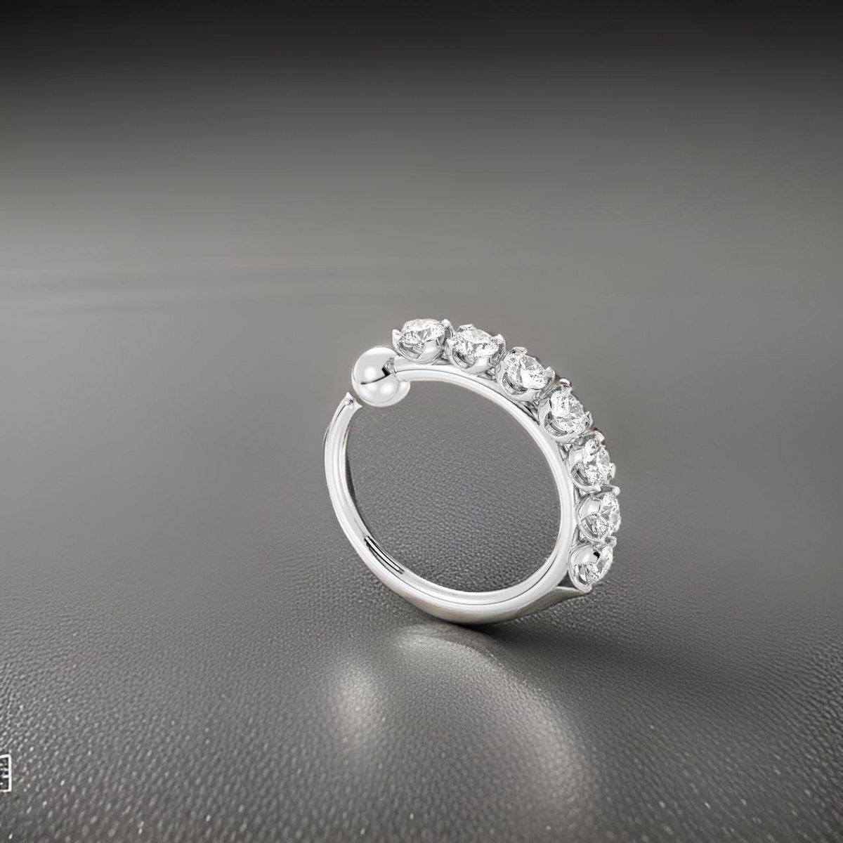 Silver ring with diamonds on a gray background