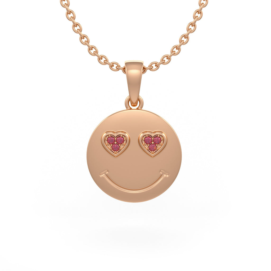 Rose gold smiley face pendant with heart shaped eyes on a white background