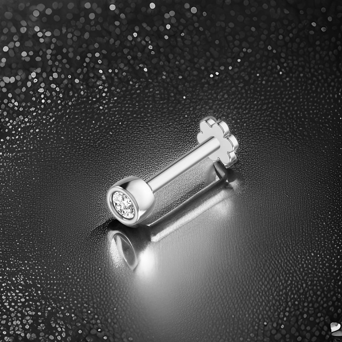 Beautiful Silver nose stude with a gemstone on a textured black background