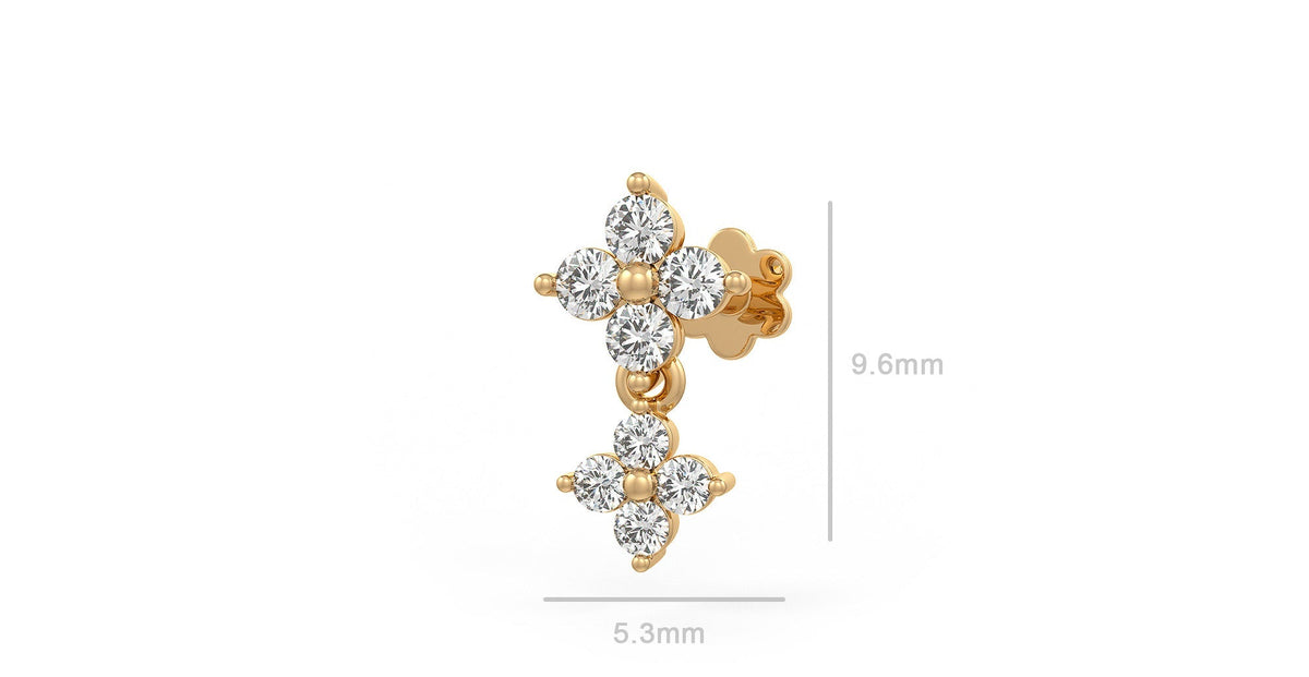 A gold nose stud  with clear gemstones with dimension lines indicating 9.6mm height and 5.3mm width