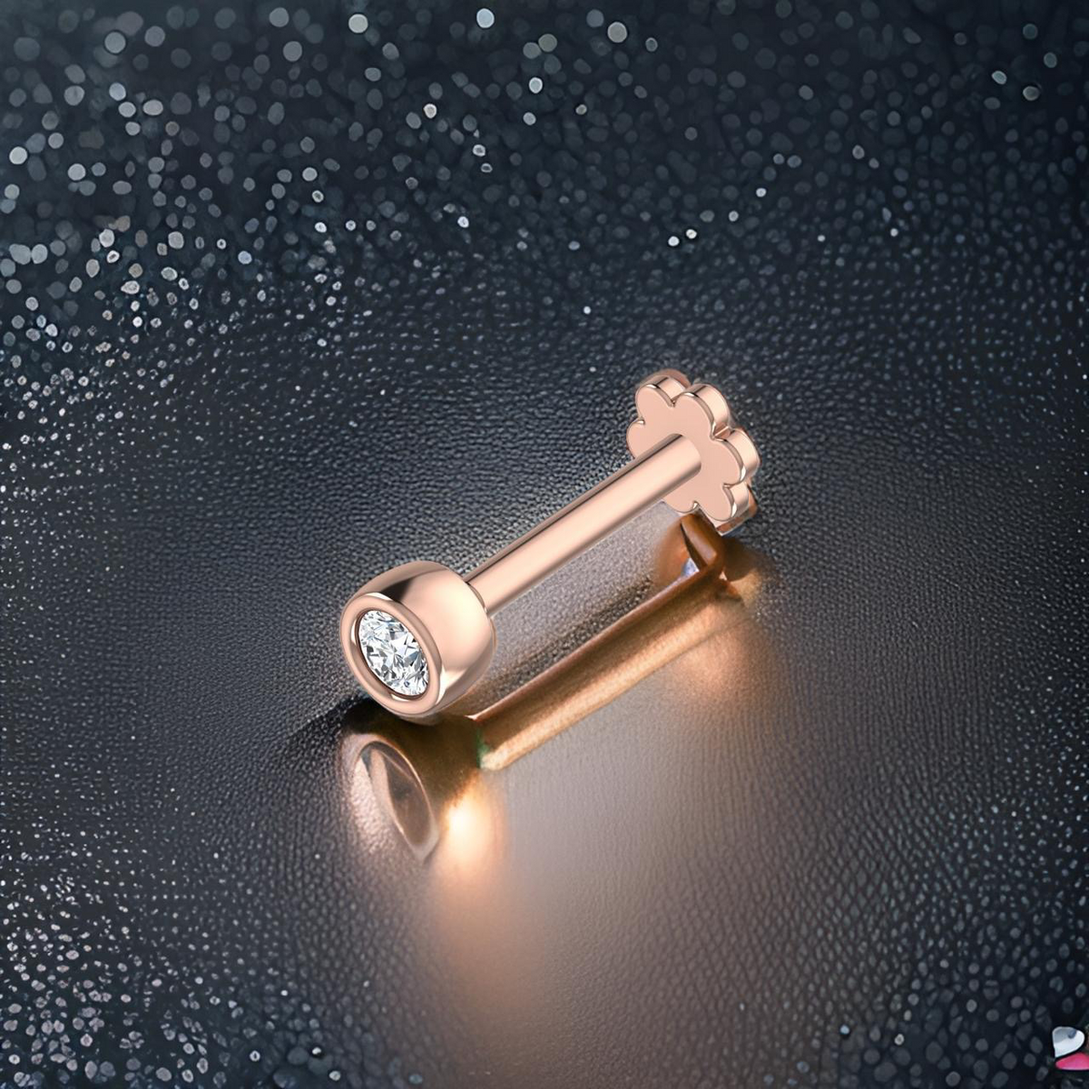 Rose gold stud with a clear gemstone on a dark textured background
