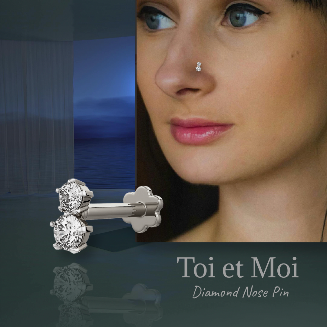 Twin diamond screwback nose stud in 18K white gold shown worn on the nose with close up jewellery detail