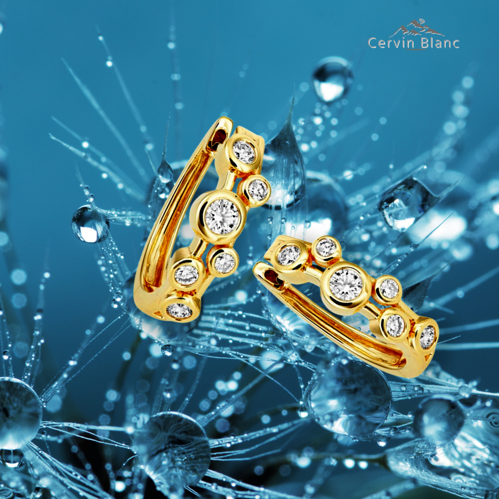 Boucles d'oreilles créoles en or jaune serties de diamants (0,50 ct).