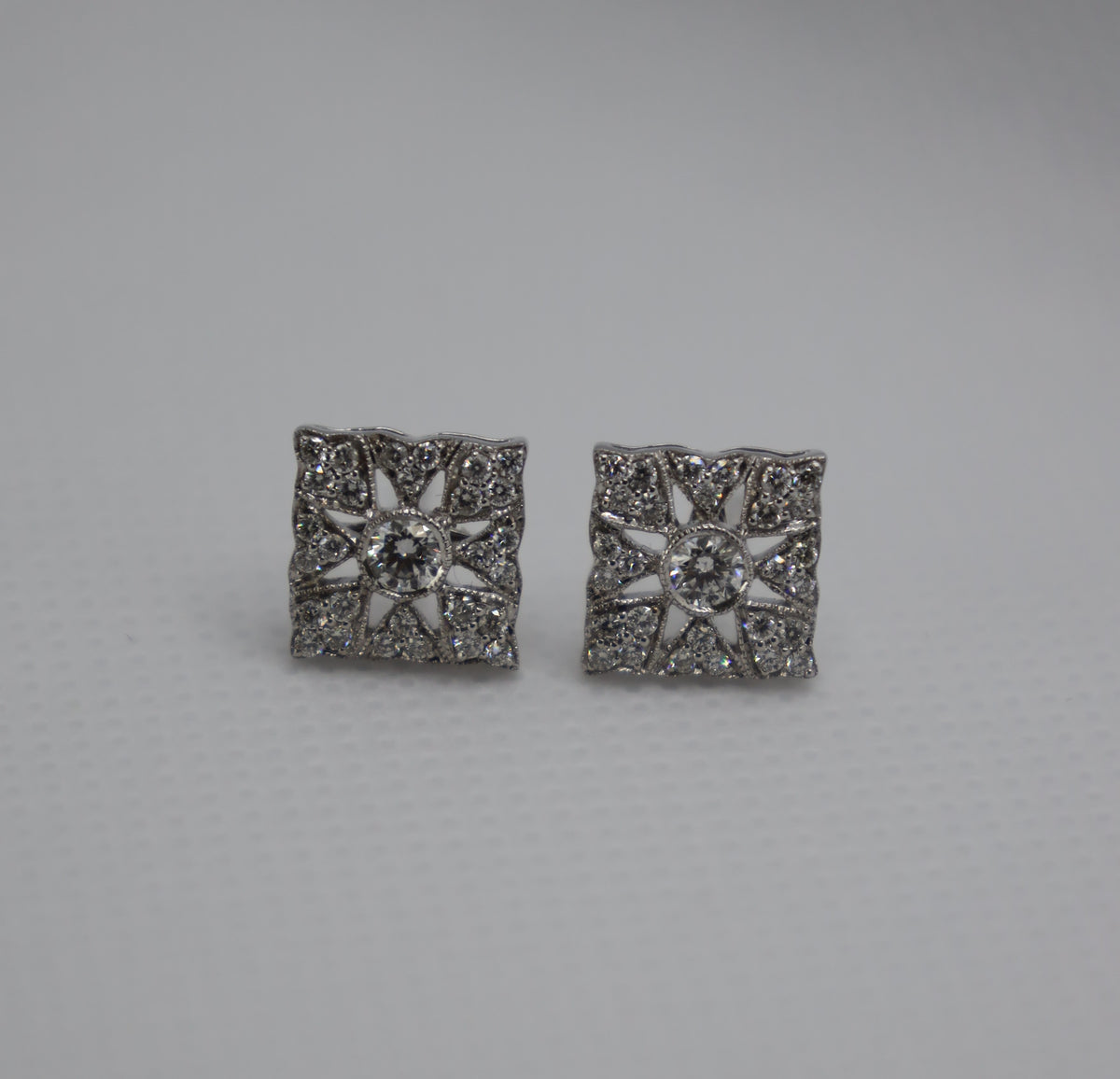 Luxury diamond earrings featuring an intricate white gold