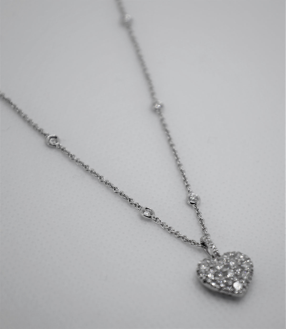 Herzförmige Halskette aus Weißgold mit verstreuten Diamanten