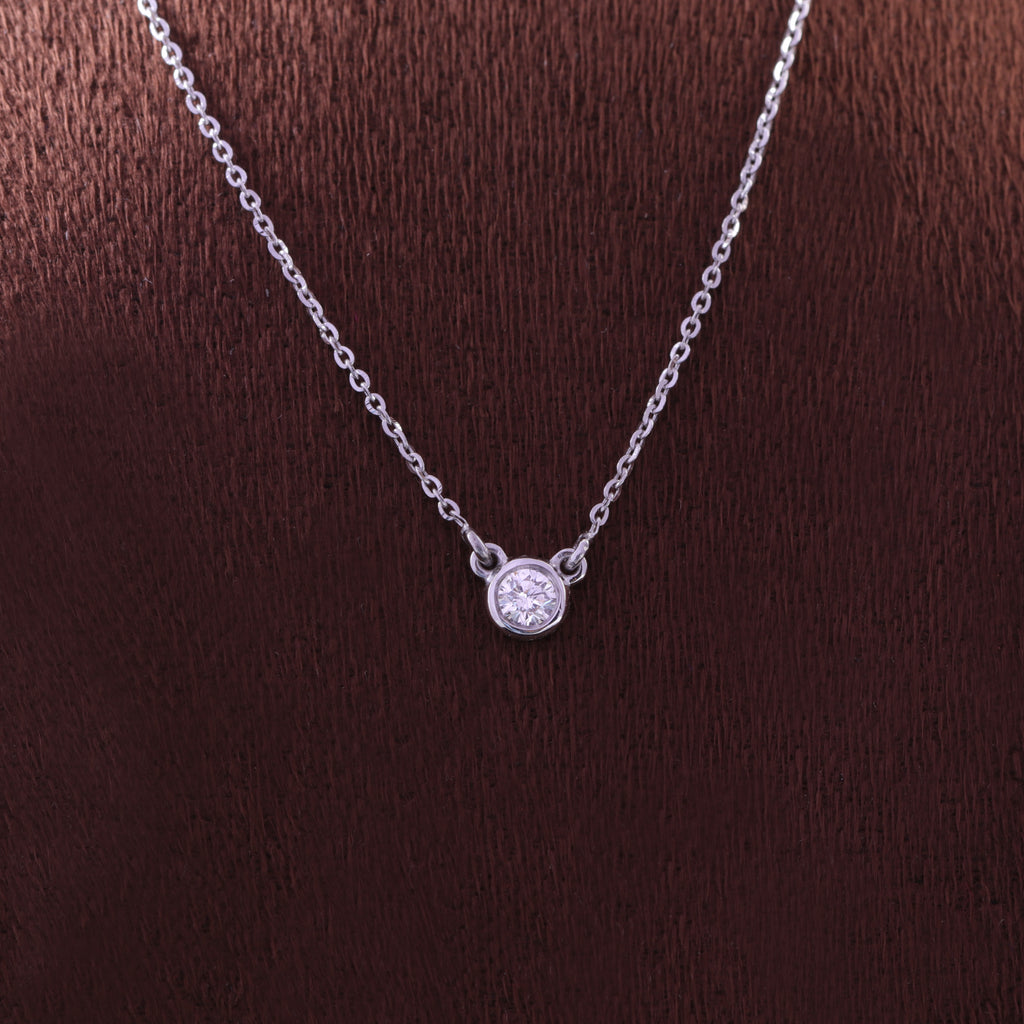 Round solitaire diamond secured in a rose gold bezel setting