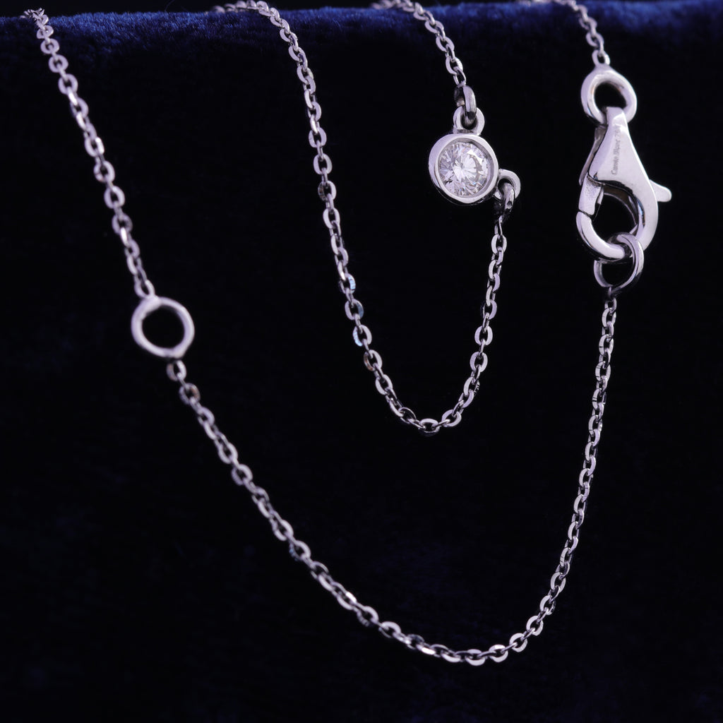 Close view of bezel set solitaire diamond necklace in rose gold