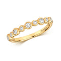 Bague demi-alliance en or 18 carats sertie de diamants et de rubis.